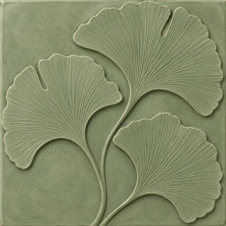Original tile concept with three finely veined ginkgo leaves in shallow relief on muted sage ceramic.